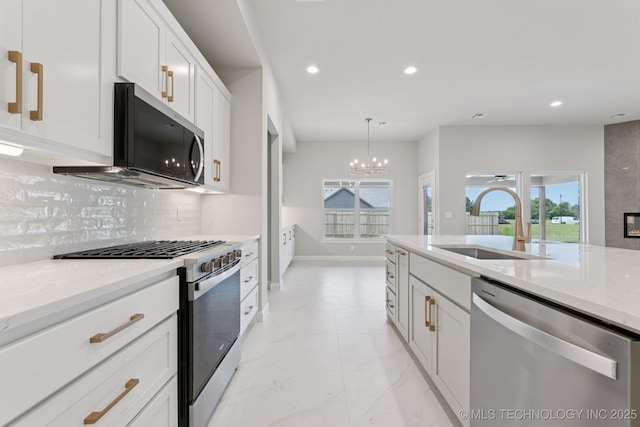 22832 E 106th Pl S, Broken Arrow, OK 74014 - kitchen with appliances with stainless steel finishes, recessed lighting, white cabinets, backsplash, and a chandelier