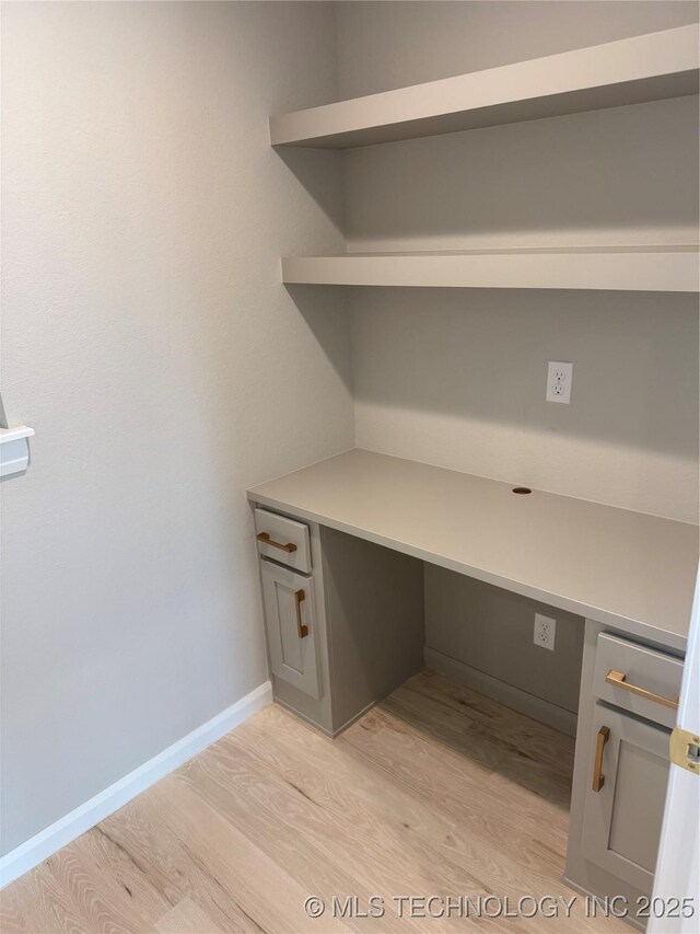 22832 E 106th Pl S, Broken Arrow, OK 74014 - unfurnished office featuring light wood-style floors, built in study area, and baseboards