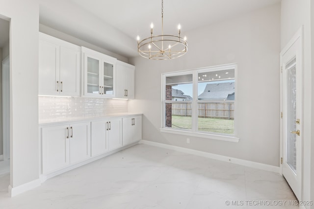 22832 E 106th Pl S, Broken Arrow, OK 74014 - unfurnished dining area with light marble finish flooring and a chandelier