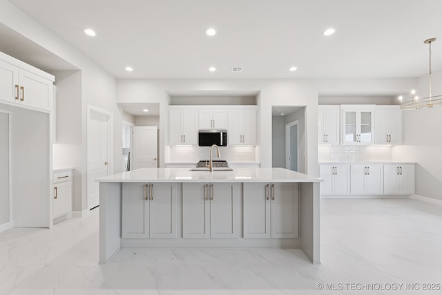 22832 E 106th Pl S, Broken Arrow, OK 74014 - kitchen featuring stainless steel microwave, backsplash, recessed lighting, and white cabinets