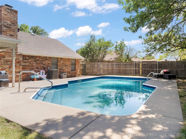 2003 8th NW, Ardmore, OK 73401 - view of swimming pool featuring a fenced backyard, a patio area, and central AC