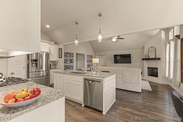 23107 E 104th Pl S, Broken Arrow, OK 74014 - kitchen featuring stainless steel appliances, a sink, vaulted ceiling, white cabinets, and light stone counters