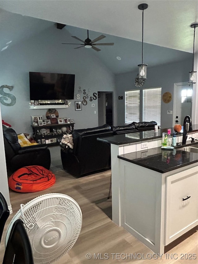 128 Crimson Ln, Calera, OK 74730 - kitchen featuring light wood finished floors, lofted ceiling, a sink, a ceiling fan, and white cabinetry