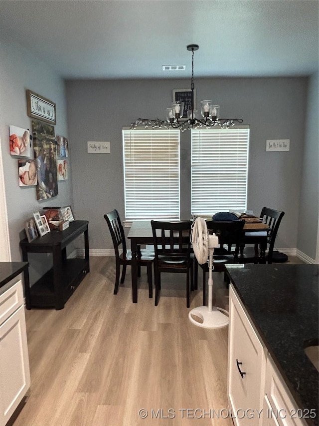 128 Crimson Ln, Calera, OK 74730 - dining space featuring a chandelier, light wood-style flooring, and baseboards