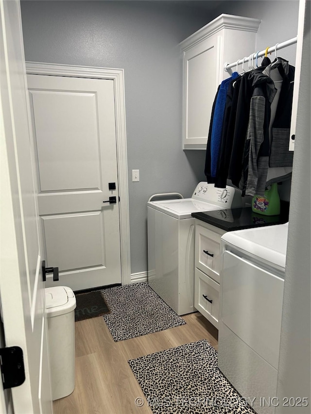128 Crimson Ln, Calera, OK 74730 - washroom featuring washer and clothes dryer, cabinet space, light wood-style flooring, and baseboards