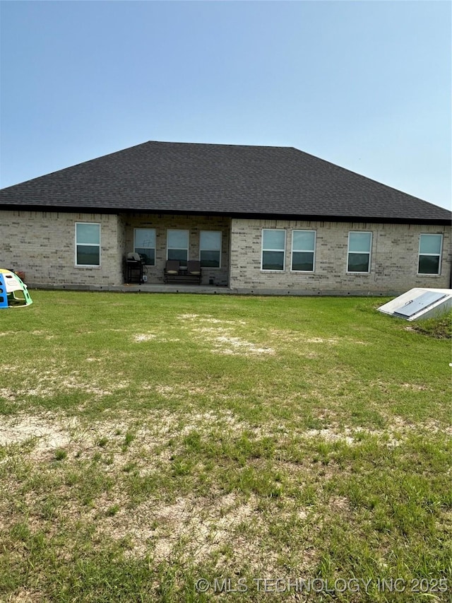 128 Crimson Ln, Calera, OK 74730 - rear view of property featuring a lawn and a shingled roof
