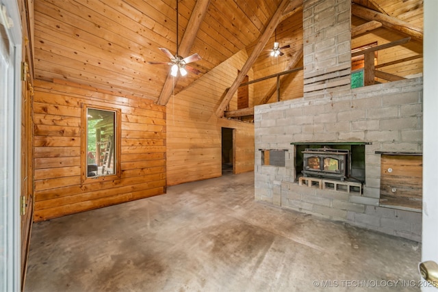 21745 E 660th Rd, Tahlequah, OK 74464 - unfurnished living room with a wood stove, wooden ceiling with exposed beams, wooden walls, unfinished concrete floors, and high vaulted ceiling