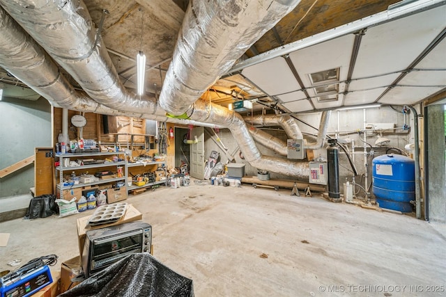 21745 E 660th Rd, Tahlequah, OK 74464 - unfinished basement featuring a water pressure tank and a workshop area