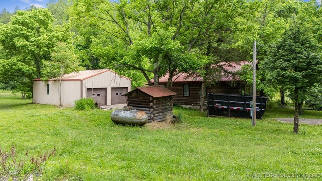 21745 E 660th Rd, Tahlequah, OK 74464 - view of grassy yard with a detached garage and an outbuilding