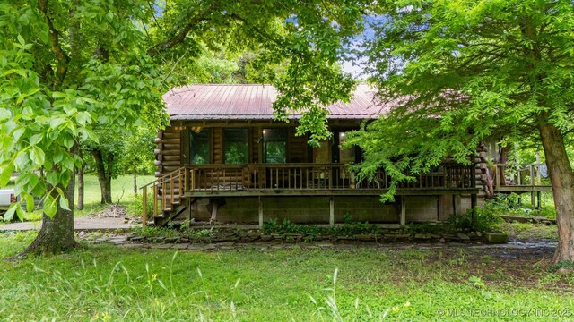 21745 E 660th Rd, Tahlequah, OK 74464 - view of front facade with log exterior, stairway, metal roof, and covered porch