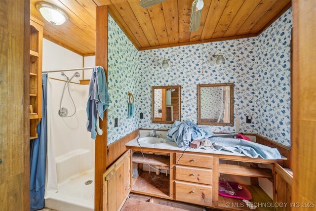 21745 E 660th Rd, Tahlequah, OK 74464 - full bathroom with wallpapered walls, a wainscoted wall, wooden ceiling, a stall shower, and double vanity
