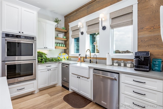 46 Red Cedar Cir, Durant, OK 74701 - kitchen with stainless steel appliances, a sink, white cabinets, light countertops, and open shelves