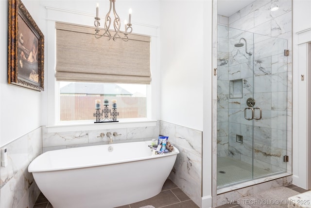 46 Red Cedar Cir, Durant, OK 74701 - bathroom featuring tile walls, a soaking tub, a shower stall, a wainscoted wall, and a chandelier