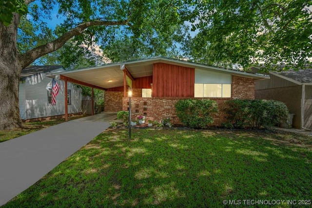 953 E 37th St, Tulsa, OK 74105 - mid-century inspired home with brick siding, driveway, a front lawn, and a carport