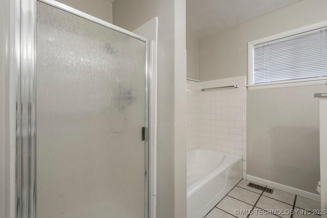 953 E 37th St, Tulsa, OK 74105 - bathroom with a shower with door, tile patterned flooring, a tub, and toilet
