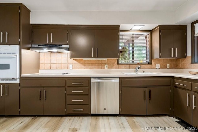 953 E 37th St, Tulsa, OK 74105 - kitchen with dishwasher, under cabinet range hood, white oven, and light countertops