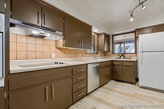 953 E 37th St, Tulsa, OK 74105 - kitchen featuring freestanding refrigerator, stainless steel dishwasher, light wood-style flooring, under cabinet range hood, and light countertops