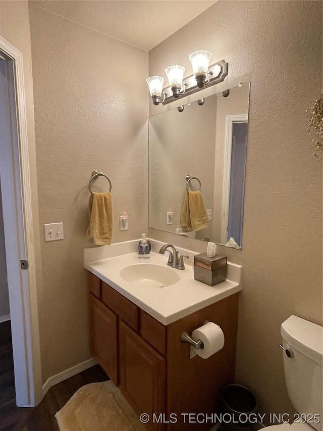 141 W Fairlane Pl, Sapulpa, OK 74066 - bathroom with vanity, toilet, and wood finished floors