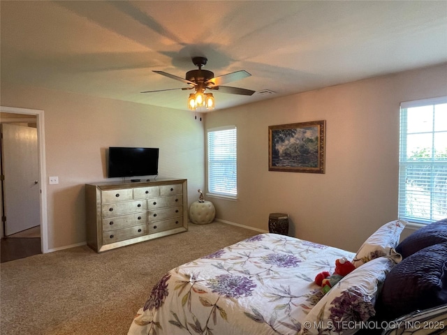 141 W Fairlane Pl, Sapulpa, OK 74066 - carpeted bedroom with multiple windows, a ceiling fan, and baseboards