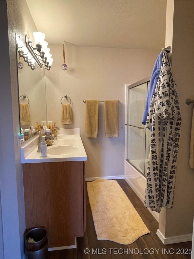 141 W Fairlane Pl, Sapulpa, OK 74066 - full bathroom featuring vanity, combined bath / shower with glass door, baseboards, and wood finished floors