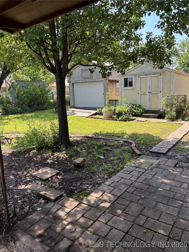 1339 E 9th St, Cushing, OK 74023 - view of green lawn featuring an outbuilding and a garage
