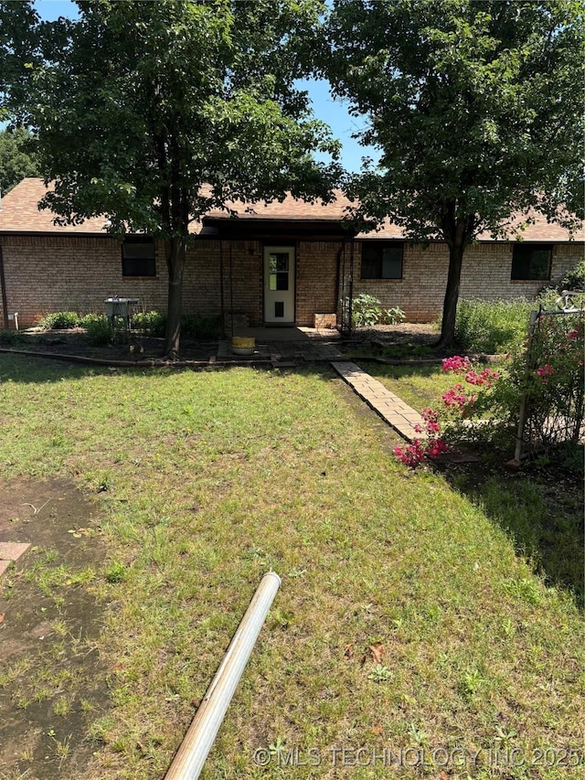 1339 E 9th St, Cushing, OK 74023 - view of front facade with a front lawn and brick siding