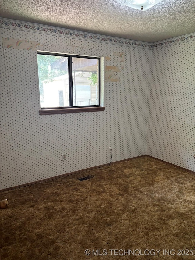 1339 E 9th St, Cushing, OK 74023 - unfurnished room featuring a textured ceiling, carpet, and wallpapered walls