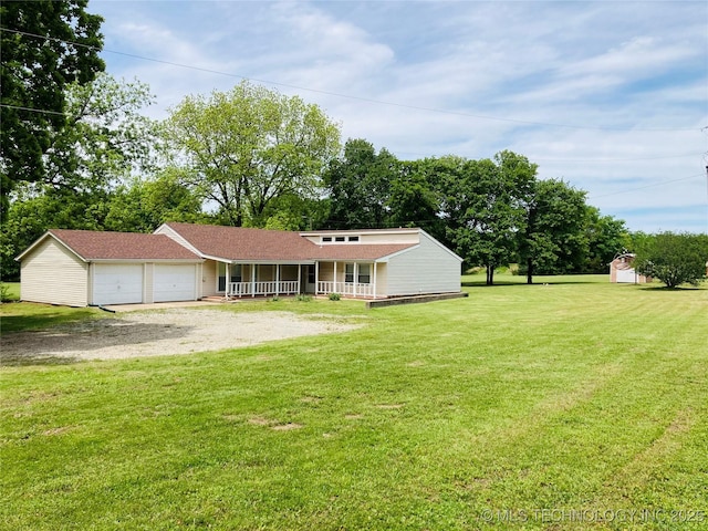 3814 E Dripping Springs Rd, Cushing, OK 74023 - view of front of house featuring a porch, a garage, dirt driveway, a front lawn, and a shed