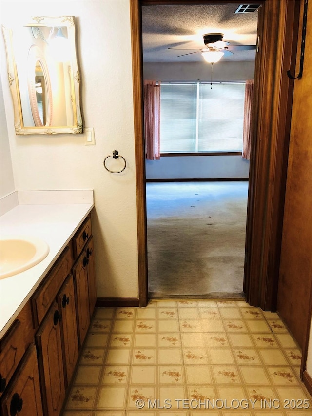 3814 E Dripping Springs Rd, Cushing, OK 74023 - bathroom featuring vanity, ceiling fan, and baseboards