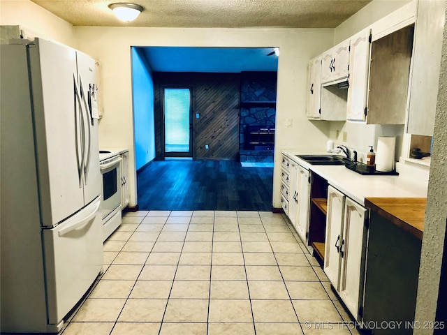 3814 E Dripping Springs Rd, Cushing, OK 74023 - kitchen with white appliances, a sink, a textured ceiling, white cabinetry, and light tile patterned floors
