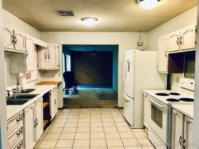 3814 E Dripping Springs Rd, Cushing, OK 74023 - kitchen featuring white electric range, a sink, light countertops, a textured ceiling, and light tile patterned floors