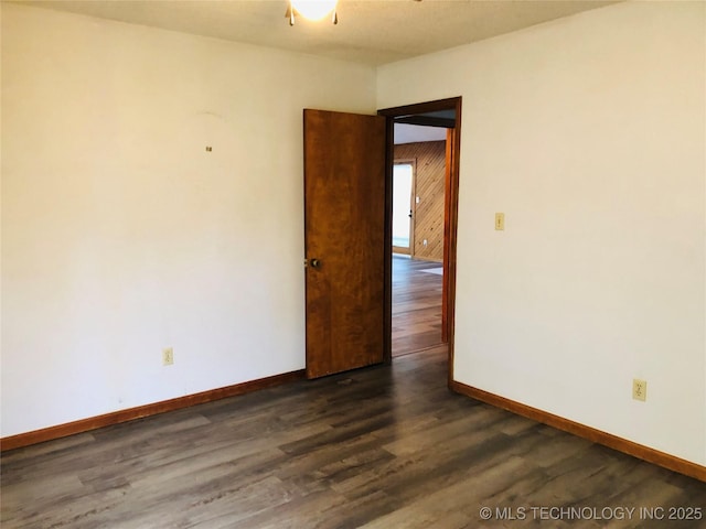 3814 E Dripping Springs Rd, Cushing, OK 74023 - empty room with dark wood-type flooring and baseboards