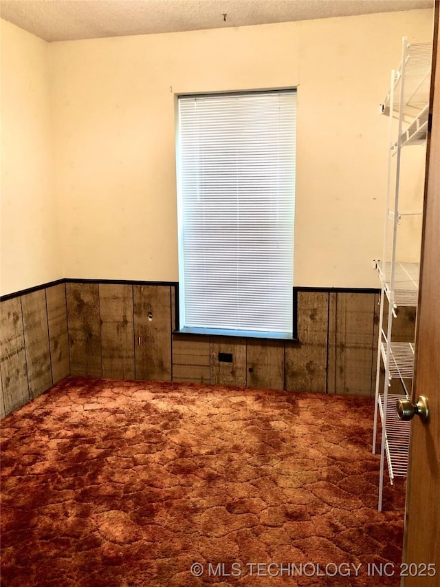 3814 E Dripping Springs Rd, Cushing, OK 74023 - empty room featuring carpet flooring and wainscoting