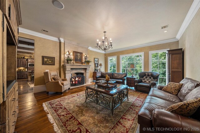 10144 N Dover Pl, Owasso, OK 74055 - living room featuring a chandelier, dark wood finished floors, a large fireplace, and crown molding