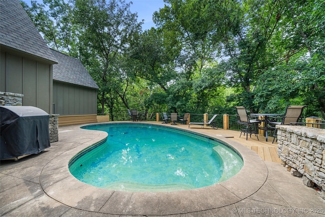 10144 N Dover Pl, Owasso, OK 74055 - view of swimming pool featuring a grill, view of scattered trees, and outdoor dining area