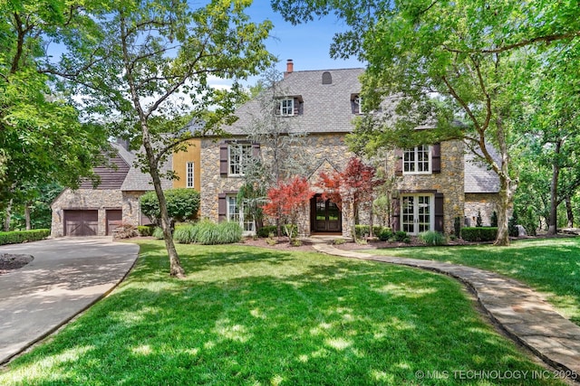 10144 N Dover Pl, Owasso, OK 74055 - english style home with stone siding, french doors, a front lawn, and a chimney