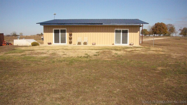 11477 State Highway 70, Madill, OK 73446 - rear view of property with board and batten siding, metal roof, and a yard