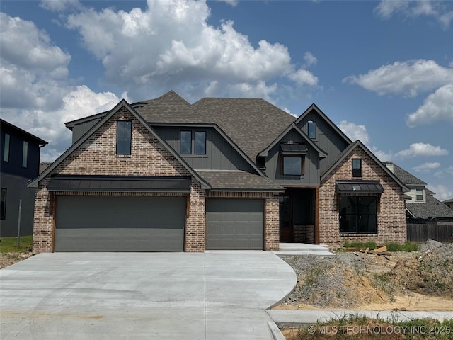 14533 S College Ave, Bixby, OK 74008 - view of front of house featuring concrete driveway, roof with shingles, board and batten siding, brick siding, and a garage