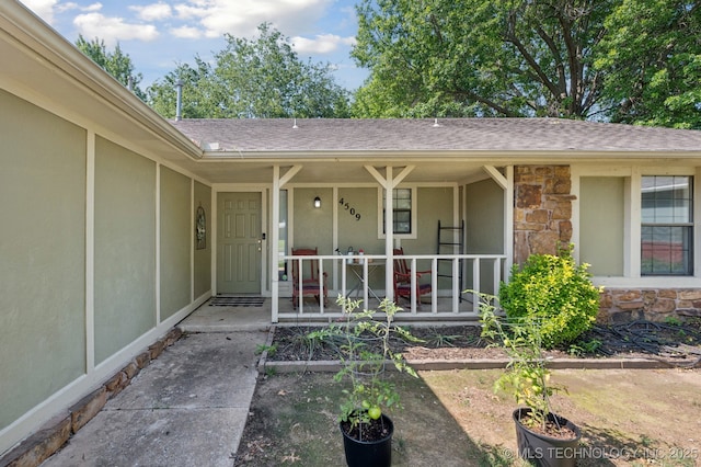 4509 W Toledo St, Broken Arrow, OK 74012 - entrance to property featuring stone siding, roof with shingles, stucco siding, and covered porch