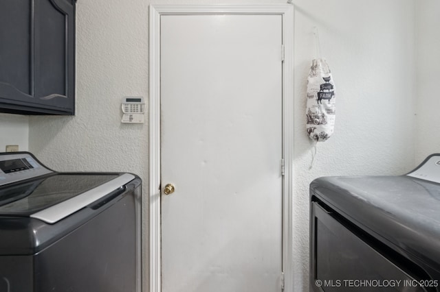4509 W Toledo St, Broken Arrow, OK 74012 - laundry area with washing machine and clothes dryer, cabinet space, and a textured wall