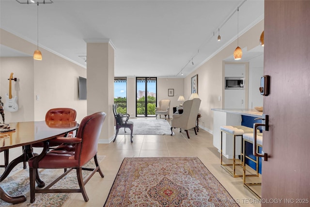 2300 Riverside Dr Unit 7A, Tulsa, OK 74114 - dining space featuring track lighting, baseboards, crown molding, and expansive windows
