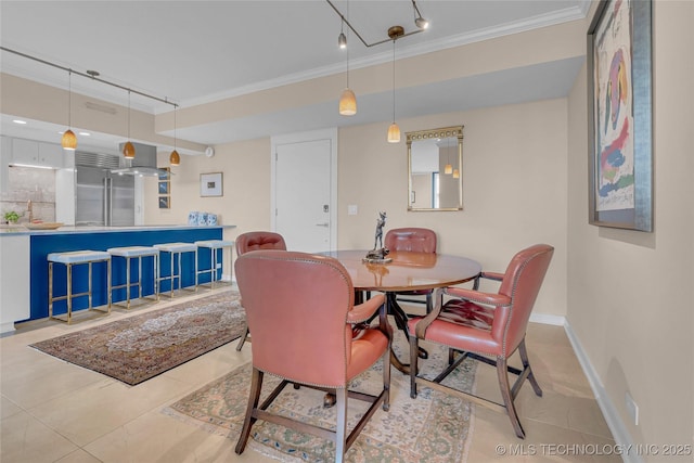 2300 Riverside Dr Unit 7A, Tulsa, OK 74114 - tiled dining room with ornamental molding, rail lighting, and baseboards
