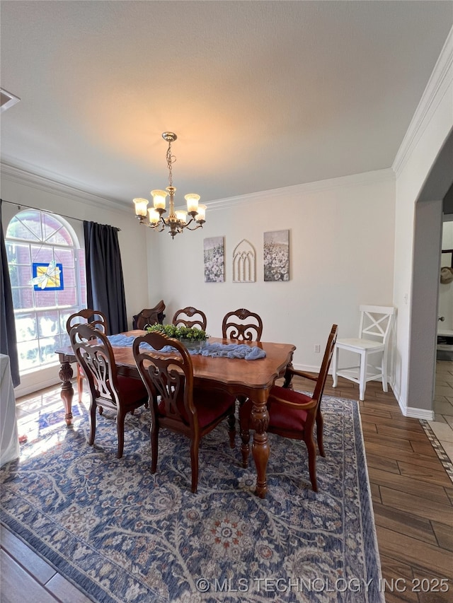 1816 W Sandusky St, Broken Arrow, OK 74012 - dining area with ornamental molding, a chandelier, wood finished floors, and baseboards