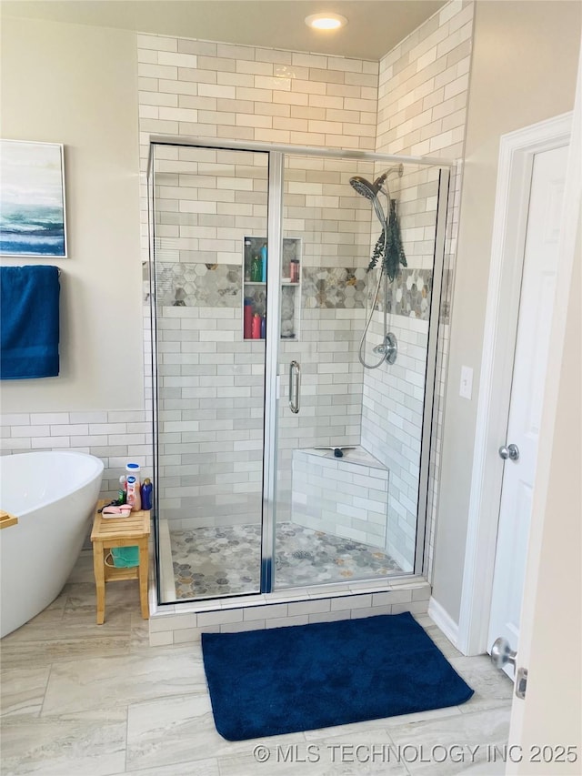 1816 W Sandusky St, Broken Arrow, OK 74012 - bathroom featuring a freestanding tub, a stall shower, and tile walls