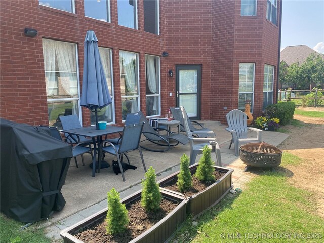 1816 W Sandusky St, Broken Arrow, OK 74012 - view of patio / terrace featuring an outdoor fire pit, area for grilling, and a vegetable garden