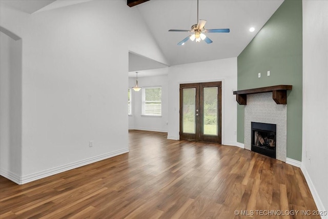 153 Founders Ln, Durant, OK 74701 - unfurnished living room featuring a fireplace, high vaulted ceiling, wood finished floors, a ceiling fan, and french doors