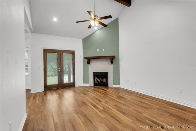 153 Founders Ln, Durant, OK 74701 - unfurnished living room featuring high vaulted ceiling, a ceiling fan, wood finished floors, a fireplace, and beam ceiling