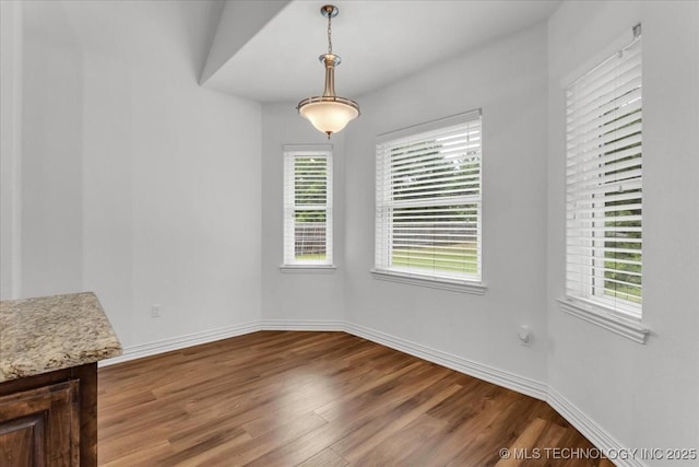 153 Founders Ln, Durant, OK 74701 - unfurnished dining area featuring wood finished floors and baseboards
