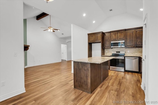 153 Founders Ln, Durant, OK 74701 - kitchen with stainless steel appliances, a ceiling fan, tasteful backsplash, a kitchen island, and dark brown cabinetry