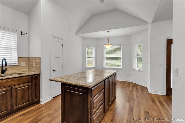 153 Founders Ln, Durant, OK 74701 - kitchen with a sink, light wood finished floors, light stone countertops, hanging light fixtures, and lofted ceiling